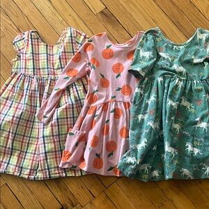 Hanna Andersson rainbow Plaid, oranges, and Unicorn Dress Trio